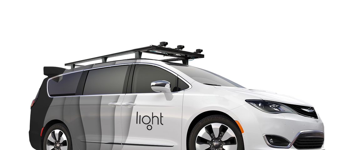 Autonomous mini van with sensors on top and Light logo on the side